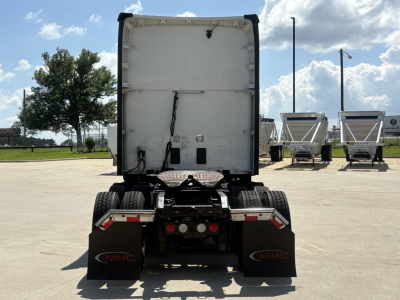 Kenworth T680 rear view showing tractor chassis and mud flaps with MHC logo.