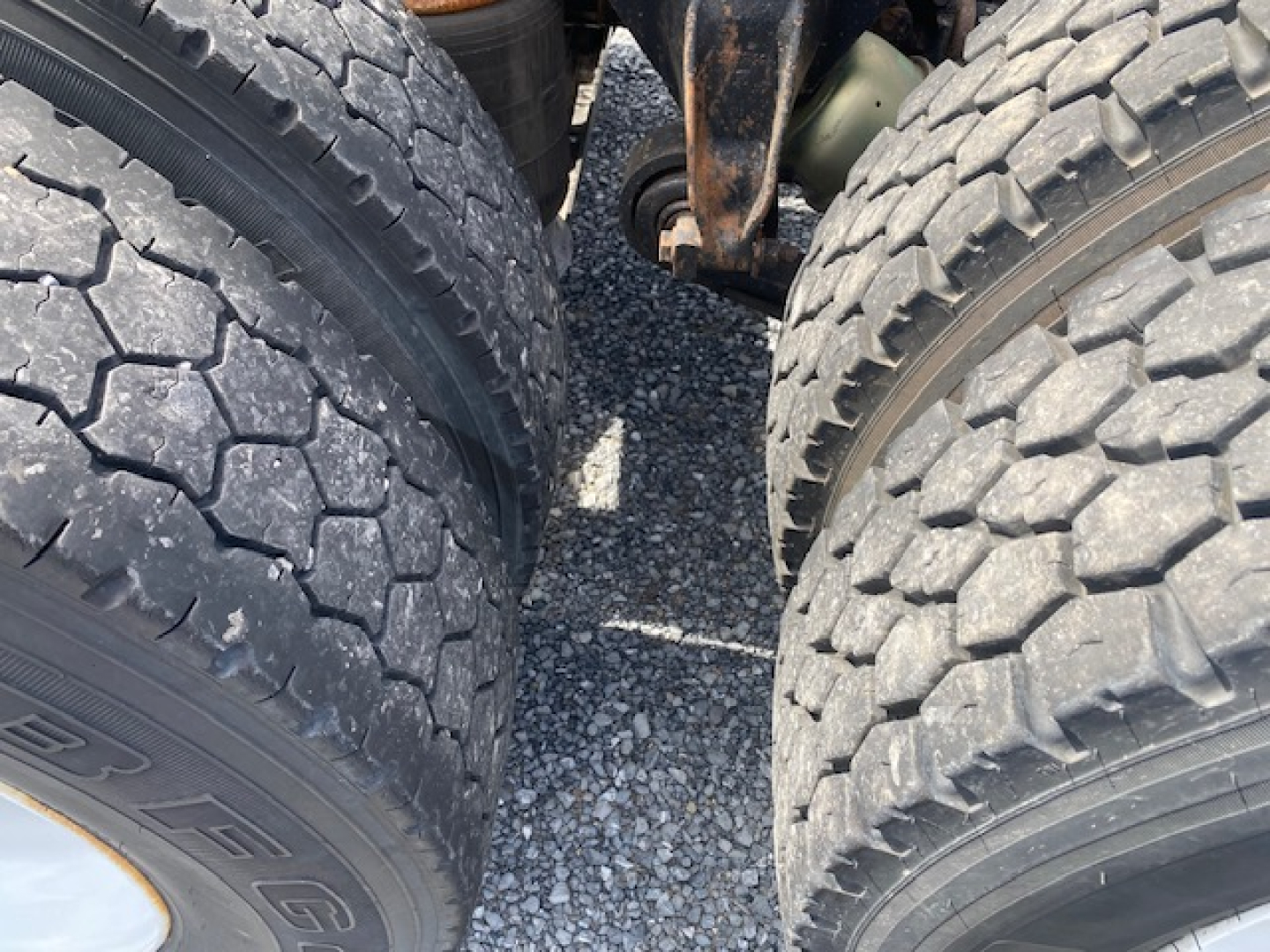 Freightliner Columbia CL120ST wheel area with dual rear tires view, showing tread and suspension components between wheels.