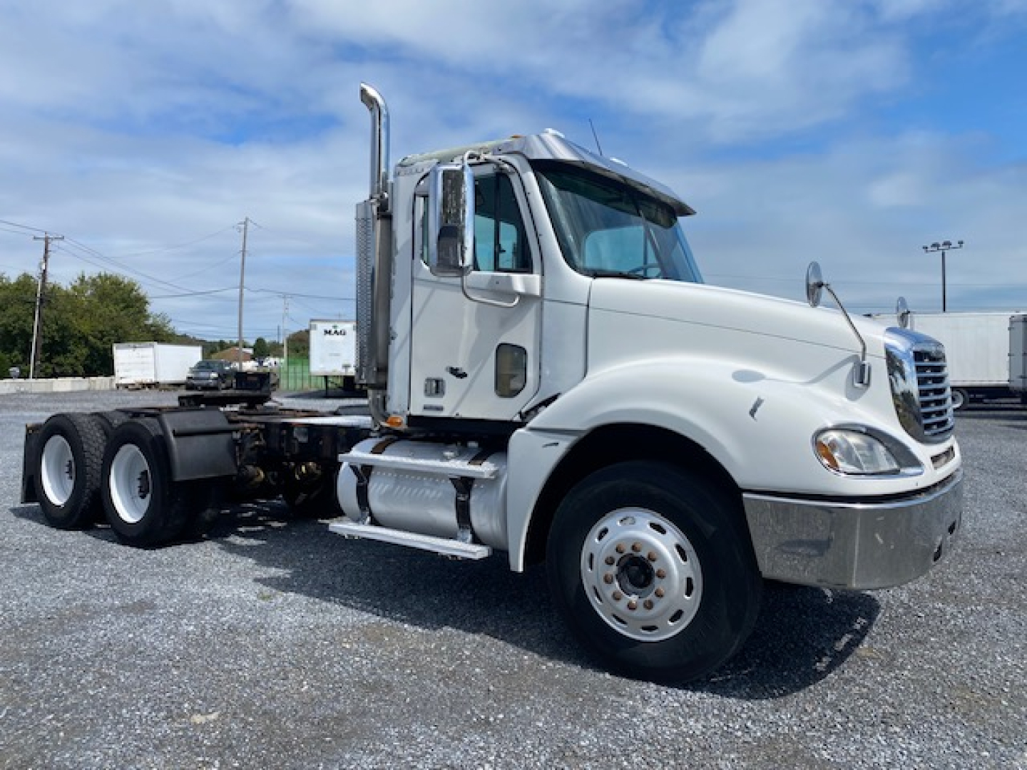 Truck cab side view showing 2007 Freightliner Columbia CL120ST with sleeper-less daycab, chrome exhaust stack, dual rear wheels, and white paint.