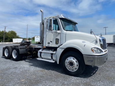 Truck cab side view showing 2007 Freightliner Columbia CL120ST with sleeper-less daycab, chrome exhaust stack, dual rear wheels, and white paint.