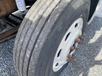 Truck wheel and dual rear tires on a Freightliner Columbia CL120ST showing large treaded tire and wheel with lug nuts.