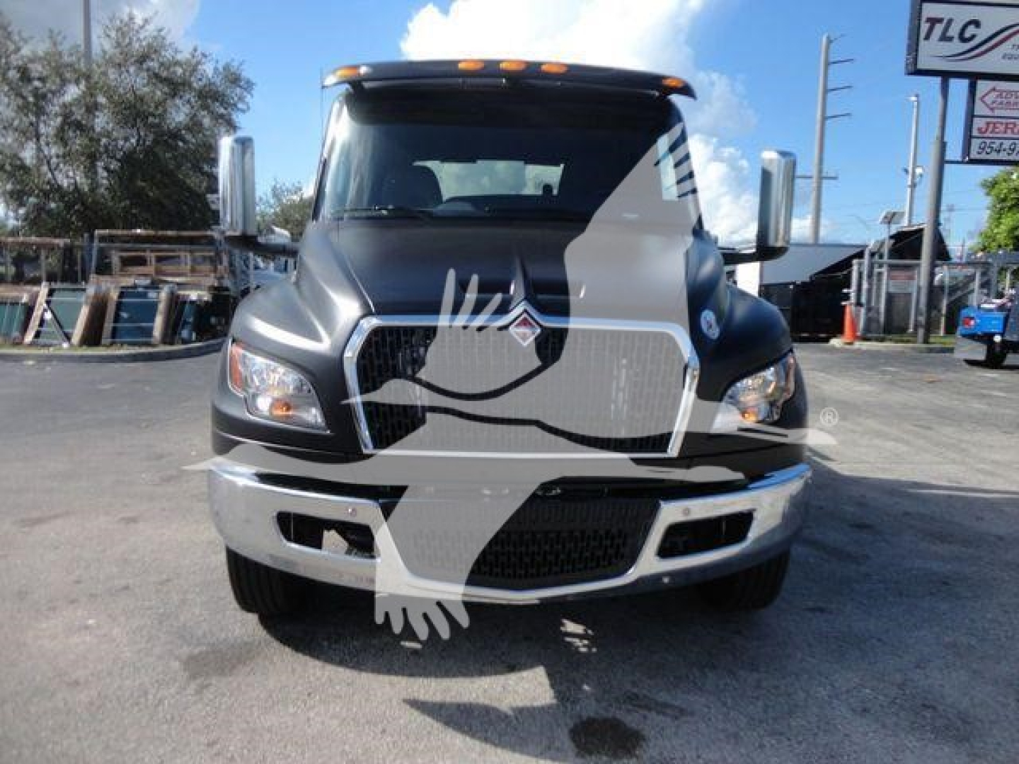 Truck front view of a new 2027 International MV rollback truck showing front grille, headlights, and bumper.