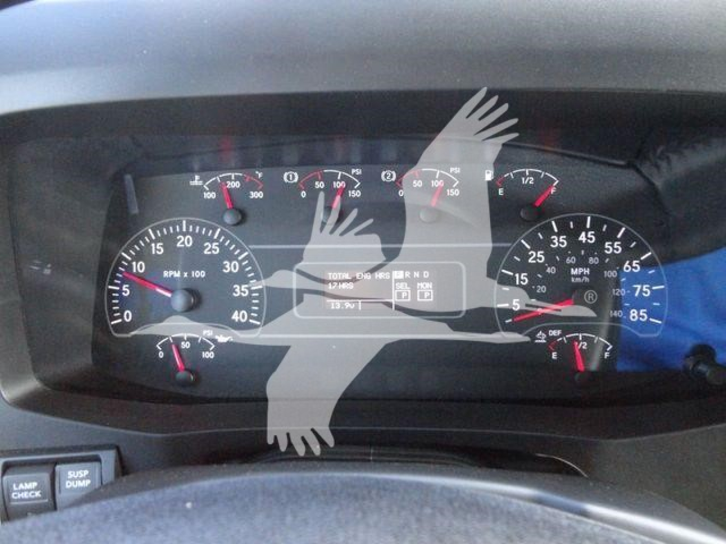Dashboard of a 2027 International MV truck showing multiple gauges including speedometer, tachometer, and warning lights in a factory/new vehicle.