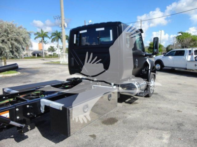 Truck cab and chassis of a 2027 International MV rollback truck showing stock number J47176 and new condition; side view with rigging and flatbed components.