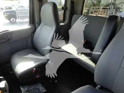 Truck cab interior showing front seats and rear bench in a clean, in-service condition.