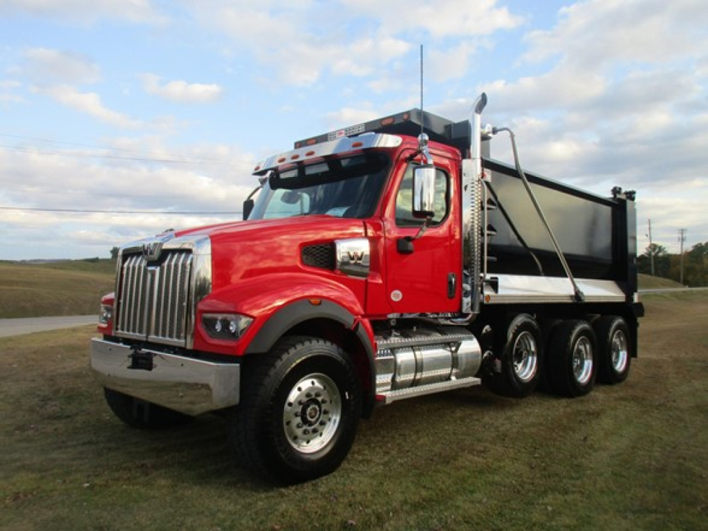 Western Star 49X dump truck in red, side view showing dump bed and twin rear axles.