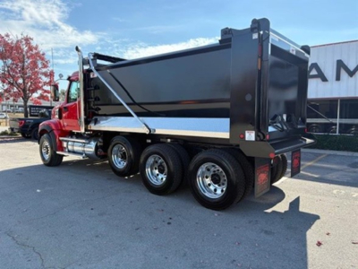 Western Star dump truck rear and side view showing dump bed and multiple wheels with chrome rims.