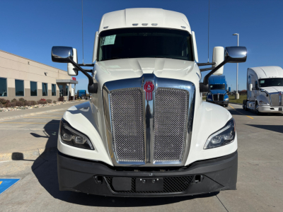 Kenworth T680 front view showing large chrome grille, black bumper, and dual mirrors; no visible text readable on image aside from standard truck design.