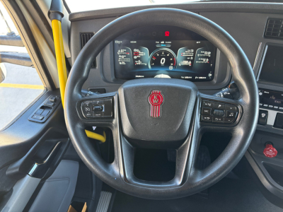 Kenworth T680 steering wheel with digital instrument cluster and control buttons in view.