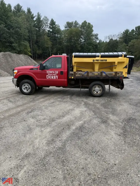 Ford F-250 Super Duty pickup with sander attachment in red cab and yellow dump bed, Town of Derby markings on door.