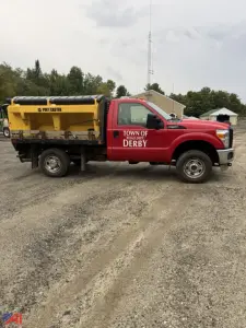 Ford F-250 Super Duty pickup truck with utility sander attachment in Ton of Derby, red cab yellow sander body.