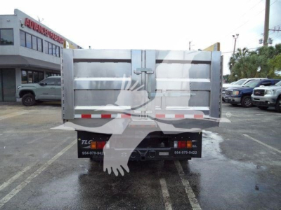 Isuzu NPR XD dump truck tailgate and bed viewing from rear with reflective tape.