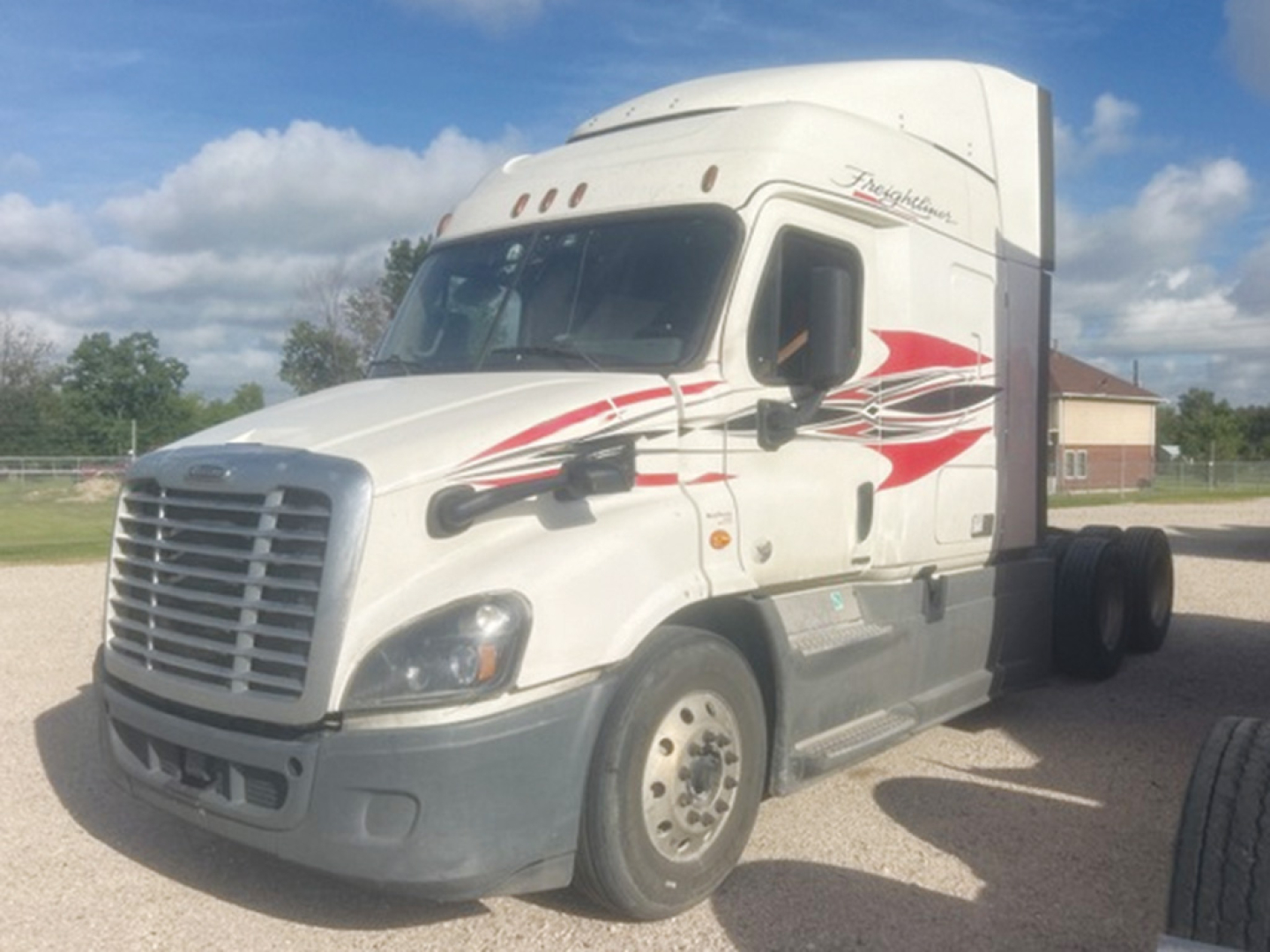 Freightliner Cascadia 113 cab with white exterior and red graphic accents, front view showing grille and 6-wheel tractor