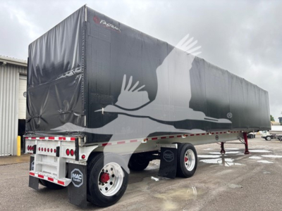 Trailer showing a curtain side with a large white graphic of a bird in flight on a black cover and red-and-white reflective tape along the lower edge. Brand name "FASTLANE" on front corner.