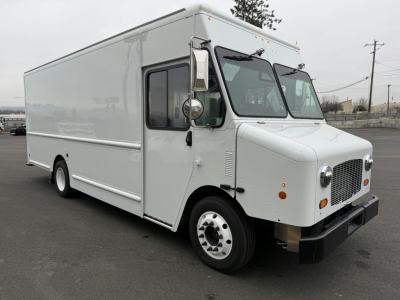Harbinger S655 step van front-right view with white body, cab over front, side window, and grille. Visible text includes Harbinger branding on grille area and a heavy-duty bumper.