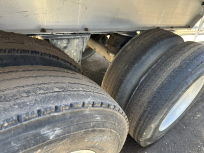Dual-tire trailer axle view with visible tires and undercarriage; no readable model text in image.
