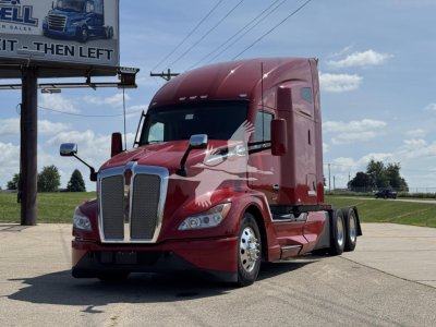 Kenworth T680 conventional sleeper tractor in red, front-left view, chrome grille, dual rear axles, VIN plate not visible.