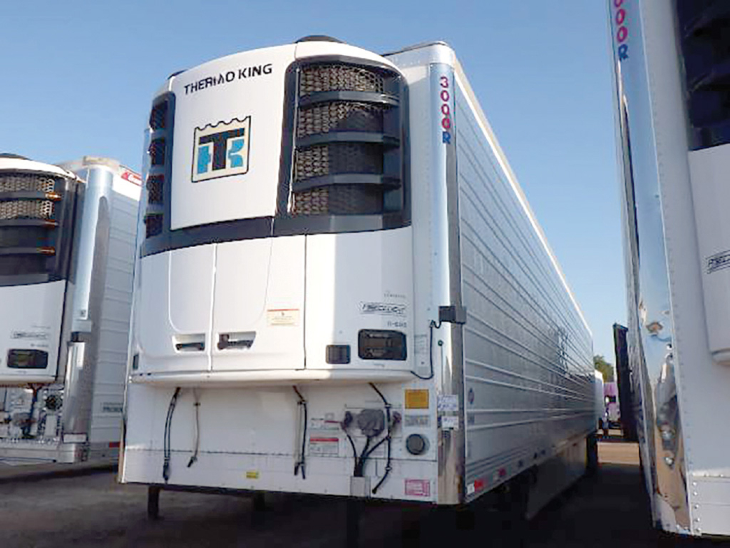 Thermo King cooling unit on front of used 2022 Utility 3000R refrigerated trailer, white with Thermo King logo and side cooling panels.