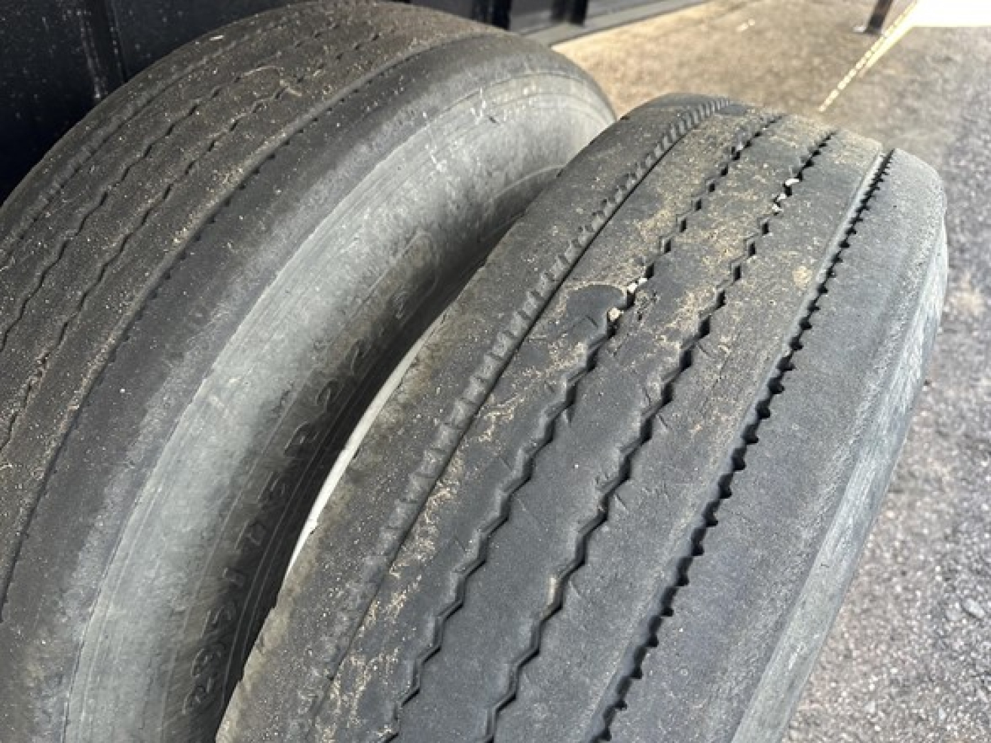 Transcraft spread air combo flatbed trailer tires and wheel area visible with tread wear along dual rear tires.
