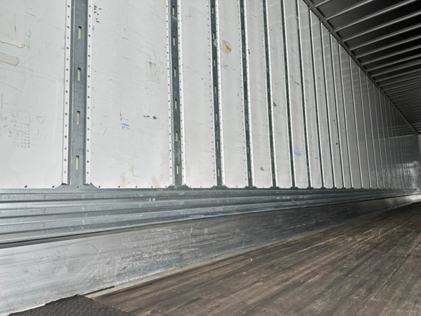 Interior of a Utility 4000Dx trailer cargo area showing metal side panels and wooden floor
