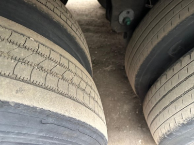 Trailer axle tires in view showing dual wheels and tread patterns; part of Utility 4000Dx trailer undercarriage visible.