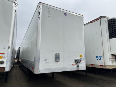 Trailer side view showing a white Utility 4000DX box trailer with number 6521 and 70105 markings, dock height feet not visible, front corner details and hitch area.