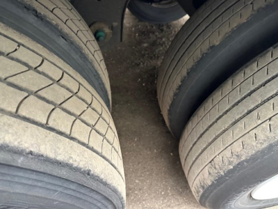 Trailer tires view with dual rear axles and tread details visible in the wheel wells.