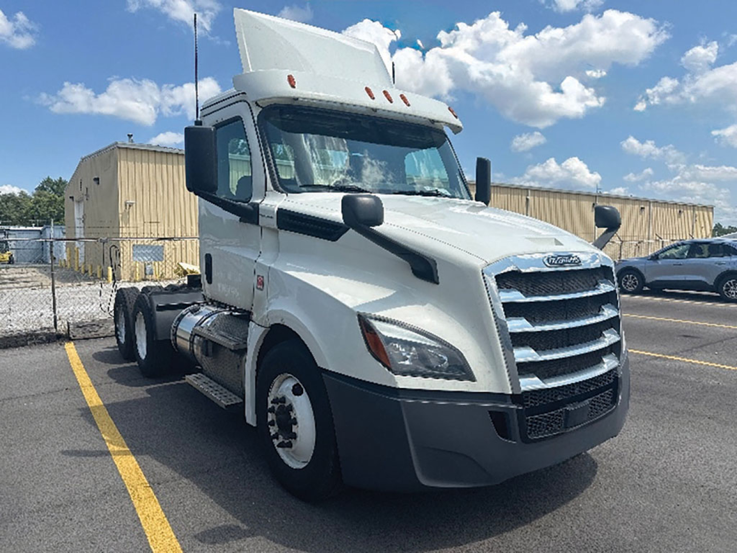 White 2019 Freightliner Cascadia126 tractor head in a parking lot, front three-quarter view, with stock number 556598 and VIN plate area visible