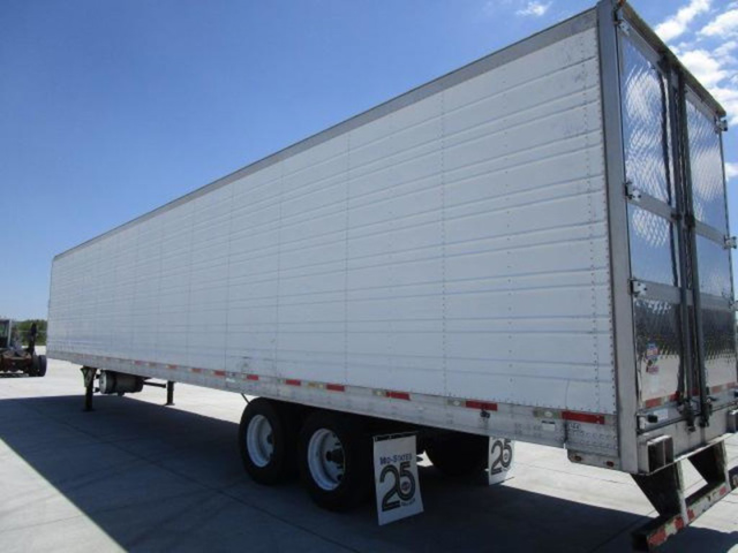 Trailer side and rear showing 2013 Utility Reefer refrigerated trailer with dual rear doors and metal framing.