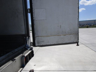 Reefer trailer cargo door open showing interior and bare concrete floor