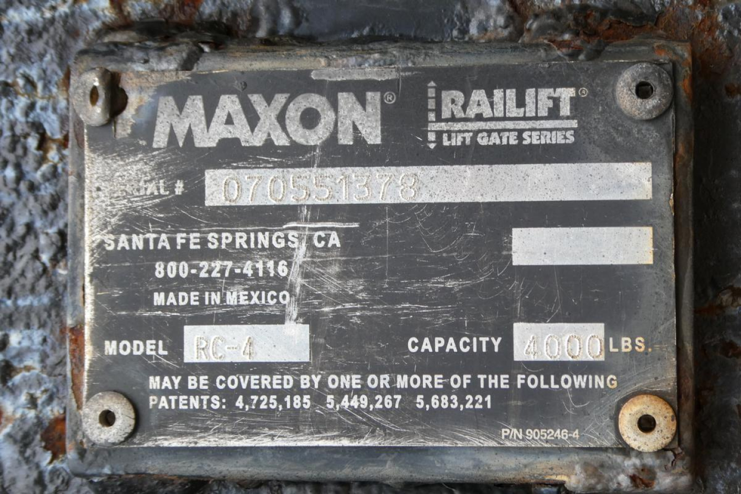 Maxon Raillift tag on metal plate showing model RC-4, capacity 4000 lbs, Santa Fe Springs CA, Made in Mexico, serial 07050513578, with riveted screws.