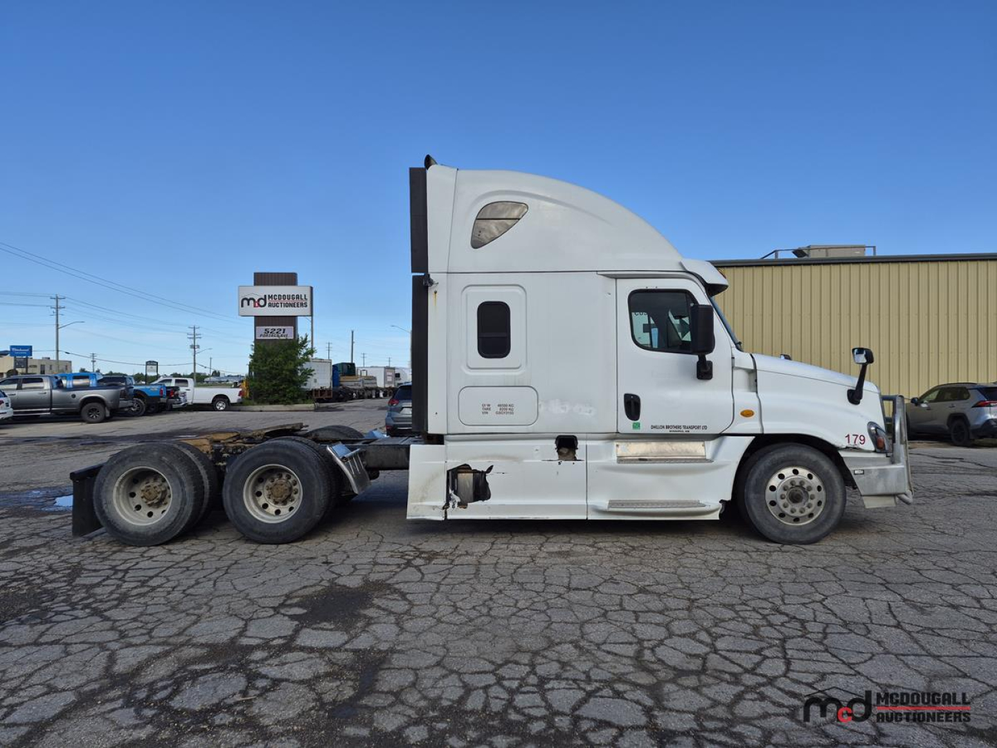 Truck side view showing 2016 Freightliner Cascadia conventional sleeper with white cab and dual rear axles.
