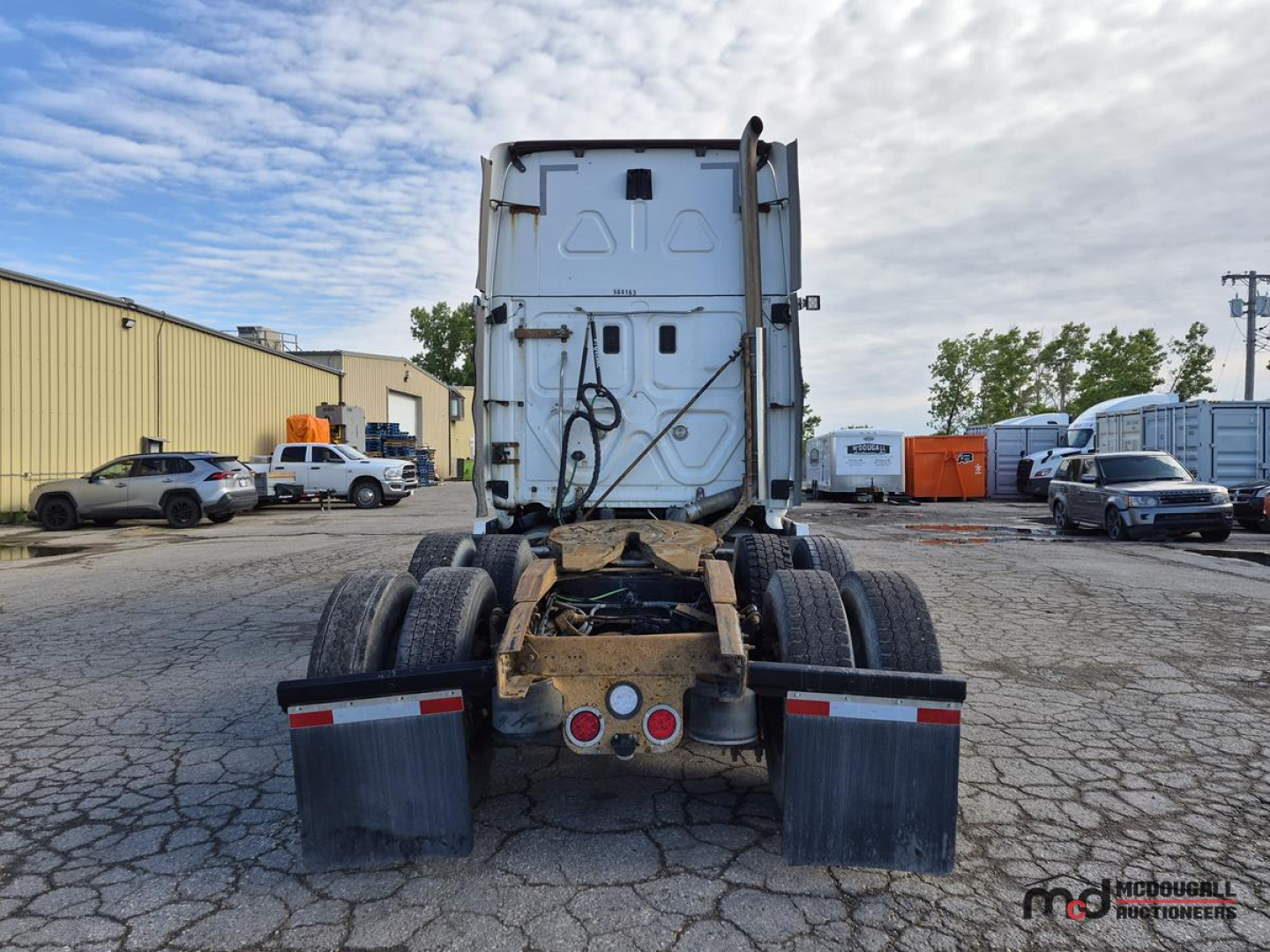 Back view of a 2016 Freightliner Cascadia tractor chassis showing rear wheels, fifth wheel area, and tail lights. VIN plate not visible.