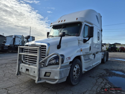Freightliner Cascadia truck in view showing front bull bar and bumper with sleeper cab, white exterior, VIN plate not legible.