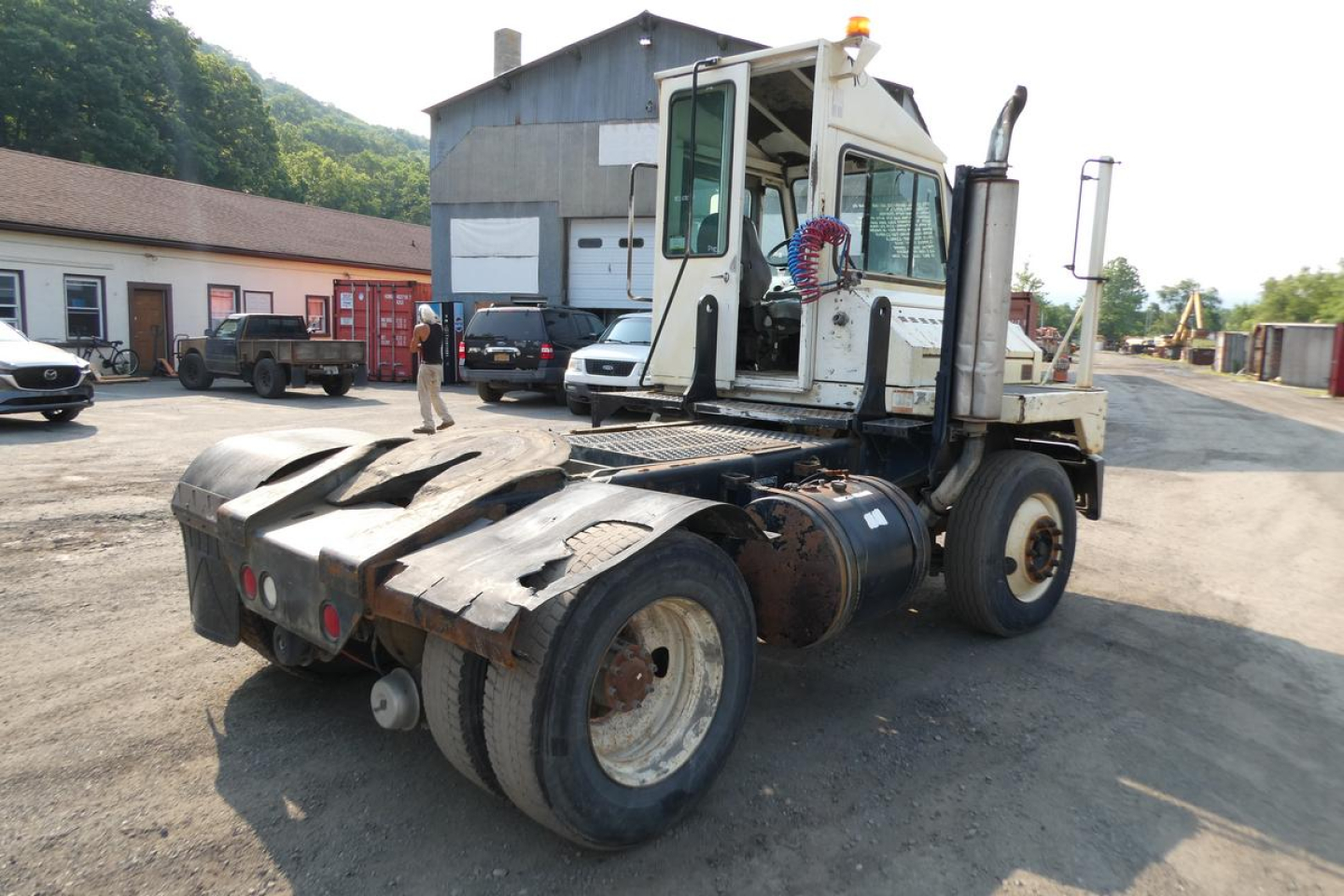 Kalmar Ottawa YT30 yard truck rear and cab view showing dual rear tires and access steps, with VIN plate area and utility hoses visible.