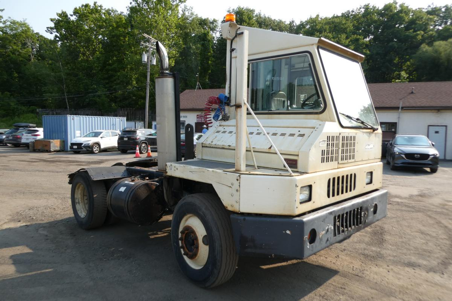 Kalmar Ottawa YT30 yard truck viewed from rear-left, showing cab, exhaust stack, and chassis.