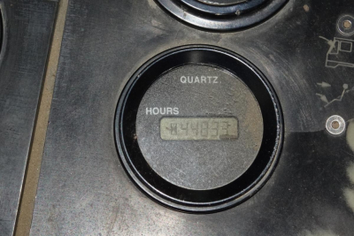 Quartz gauge showing hours on a Kalmar Ottawa YT30 yard forklift dashboard with a digital hour readout.