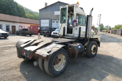 Kalmar Ottawa YT30 yard truck rear and cab view showing dual rear tires and access steps, with VIN plate area and utility hoses visible.