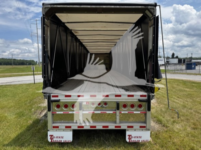 Trailer interior view of a 2018 Reitnouer Big Bubba curtainside trailer showing open rear with loading area and reflective rear bumper.