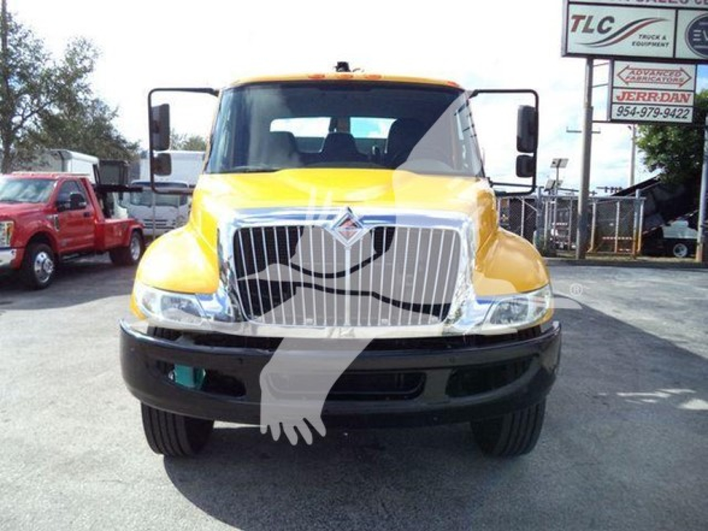 Front view of a yellow 2019 International Durastar grapple truck showing grille, bumper, and headlights.