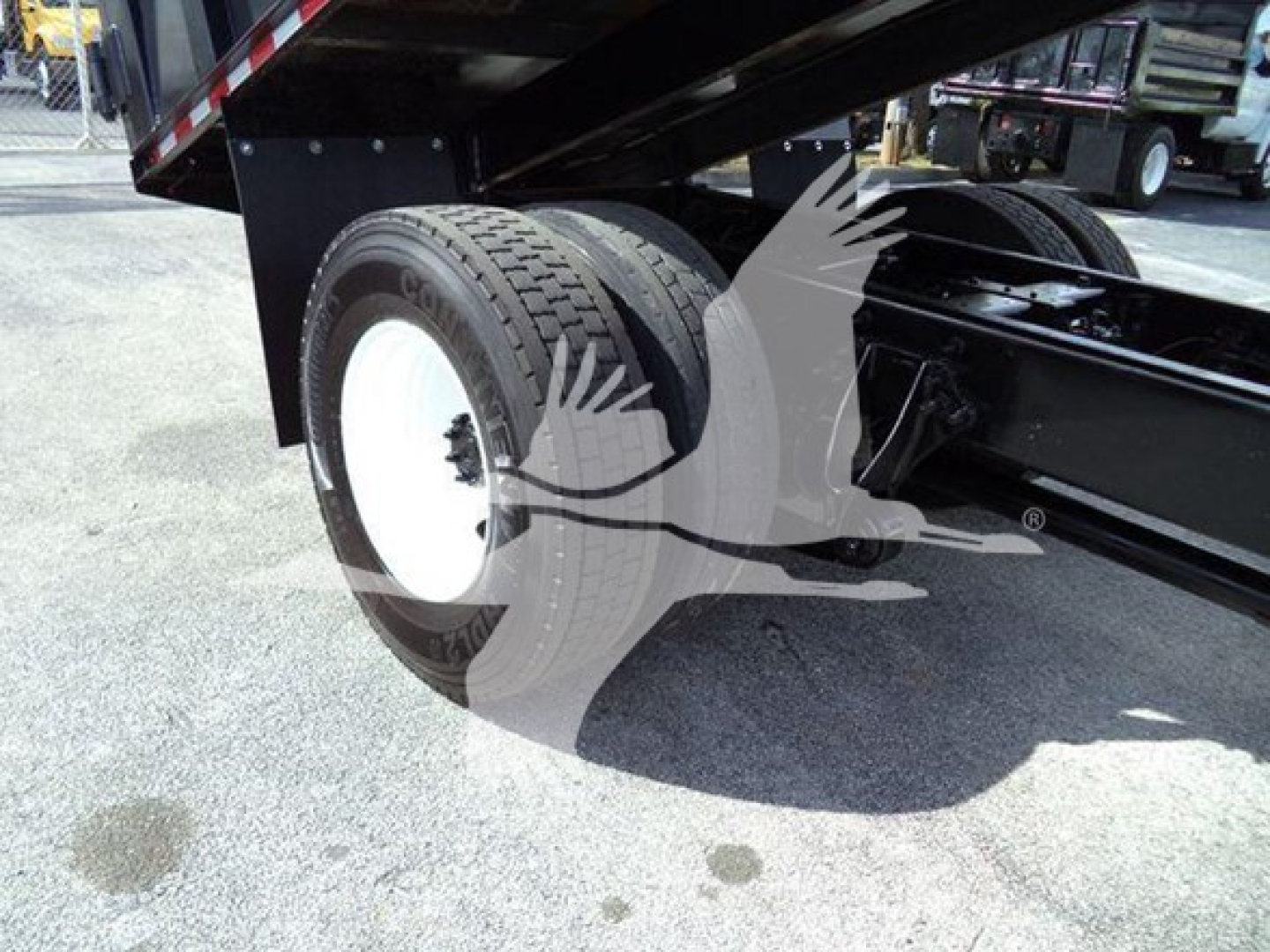 Truck rear wheel and undercarriage view showing dual rear tires on a 2019 International Durastar grapple truck.