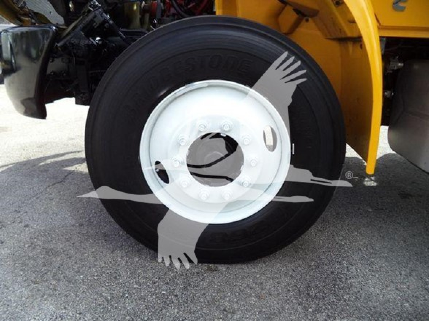 Wheel and tire of a 2019 International Durastar grapple truck showing a Bridgestone tire and white steel rim.