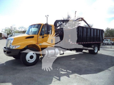2019 International Durastar dump truck with grapple; yellow cab, black dump bed, crane grapple arm on side, white wheels; visible text on rental/lot image not legible.