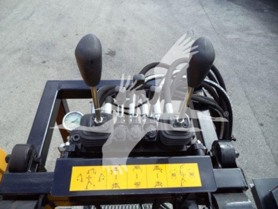 Grapple truck control levers and yellow instruction panel in cab area of 2019 International Durastar, gear levers visible with labels.