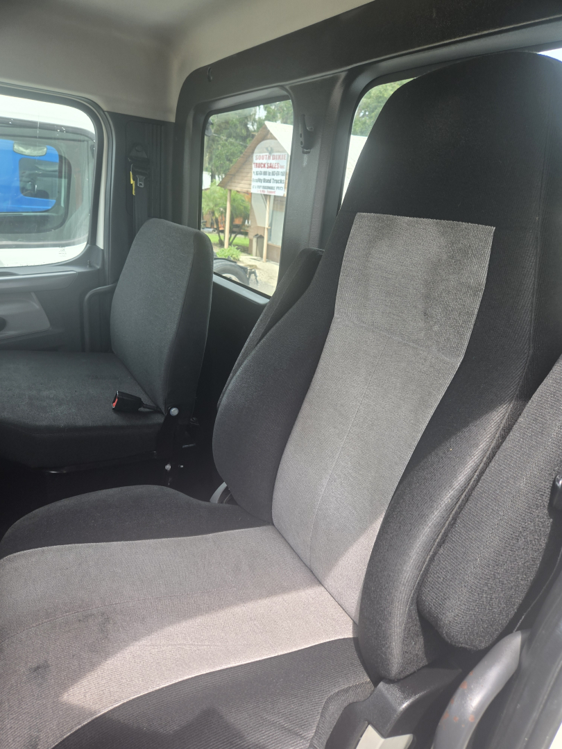 Cab interior of a 2019 Freightliner Cascadia day cab showing seats and windows.