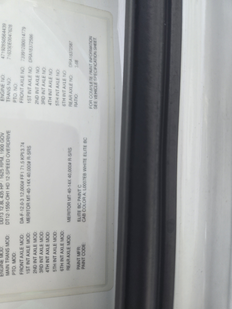 Vehicle information label on a Freightliner Cascadia day cab showing weights and specs in a vertical orientation.