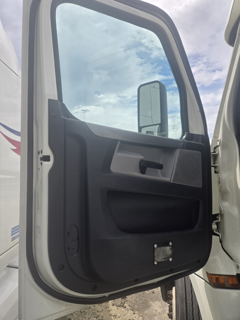 Truck cab door interior view of a 2019 Freightliner Cascadia Day Cab Tandem Class 8 showing the door panel and window.