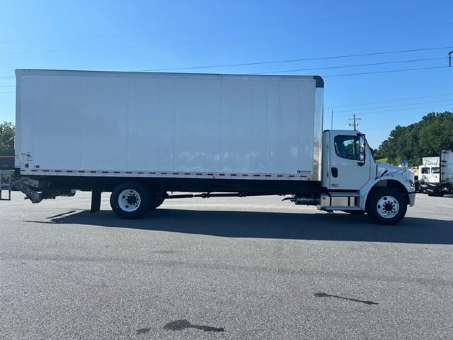 Freightliner M2 106 Plus box truck side view showing cargo box and cab with VIN label area not visible.
