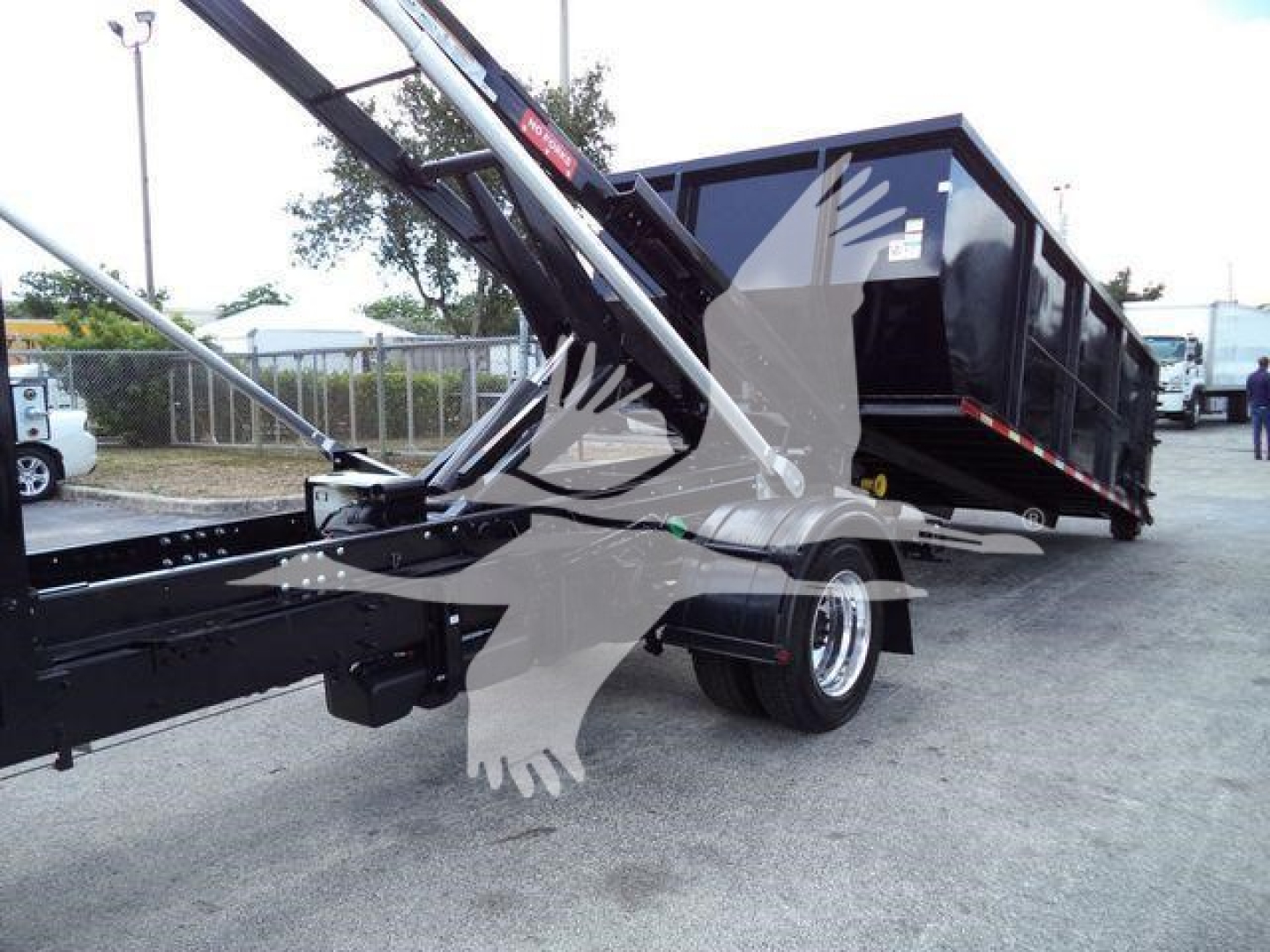 Truck body showing hydraulic lift arms and black dump bed with International logo watermark