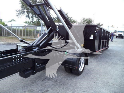 Rolloff truck chassis and dump body with hydraulic arm and hitch; no legible text visible on components